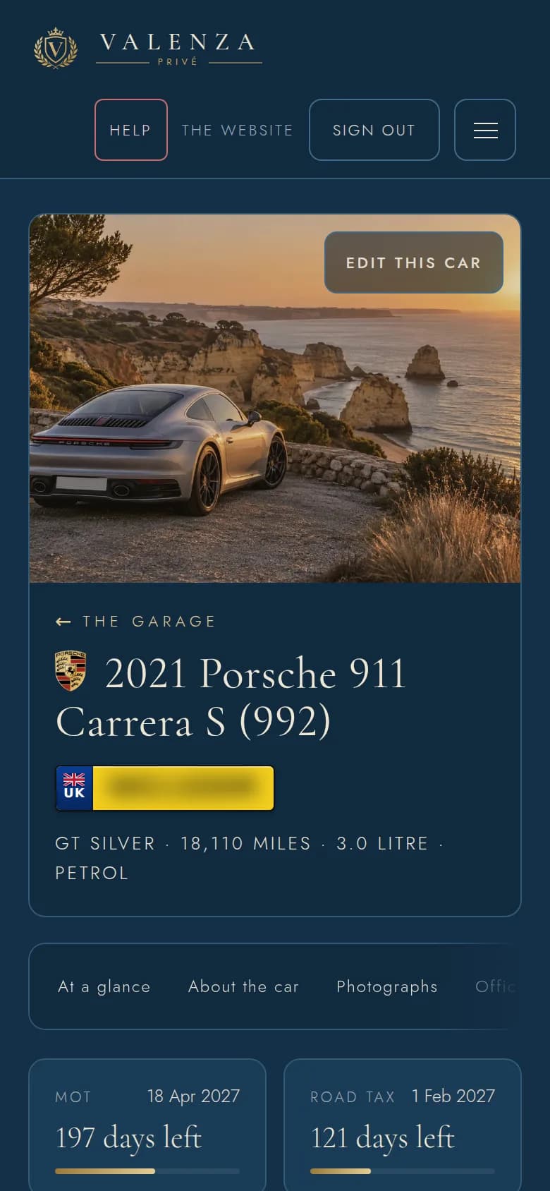 A car in the members' garage on a phone: a silver Porsche 911 on a coast road at sunset, its name, and its MOT and road tax dates counted down